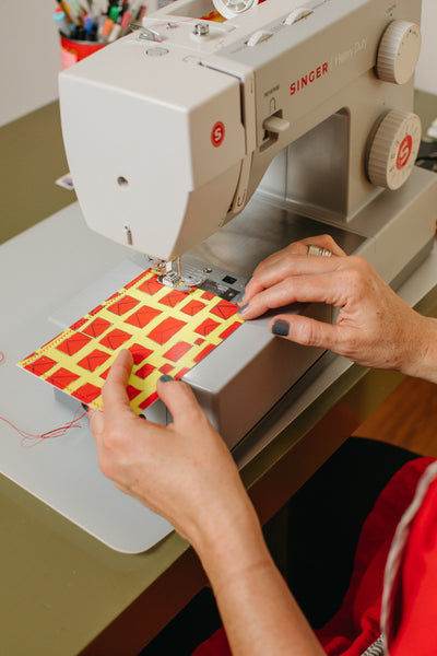 Michelle Ott stitching her illustrated postcard